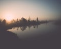 Beautiful tranquil landscape of misty swamp lake