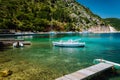 Beautiful tranquil sunny scenery of lovely greek harbor, blue sea with crystal clear water. Summer tourism vacation holidays boat Royalty Free Stock Photo