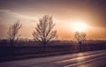 Beautiful tranquil sunset over the highway and cultivated field Royalty Free Stock Photo