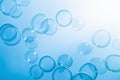 Beautiful Transparent Blue Soap Bubbles Floating in The Air. Blue Gradient Blurred Background Royalty Free Stock Photo