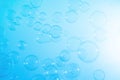 Beautiful Transparent Blue Soap Bubbles Floating in The Air. Blue Gradient Background, Refreshing of Soap Suds Bubbles Water. Royalty Free Stock Photo