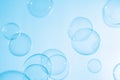 Beautiful Transparent Blue Soap Bubbles Floating in The Air. Blue Gradient Blurred Background. Royalty Free Stock Photo
