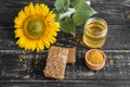 Beautiful transparent honey in bank, honeycombs and pollen on a wooden table Royalty Free Stock Photo