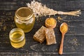 Beautiful transparent honey in bank, honeycombs and pollen on a wooden table Royalty Free Stock Photo