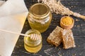 Beautiful transparent honey in bank, honeycombs and pollen on a wooden table Royalty Free Stock Photo