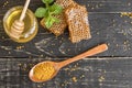 Beautiful transparent honey in bank, honeycombs and pollen on a wooden table Royalty Free Stock Photo