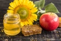 Beautiful transparent honey in bank, honeycombs and pollen on a wooden table Royalty Free Stock Photo