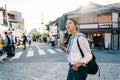 Beautiful traveler crossing the road