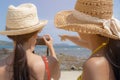 Beautiful traveler women or beautiful friend telling her friend to take beautiful photo at beautiful beach in summer season.