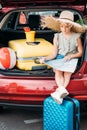 beautiful travelling girl sitting in car trunk Royalty Free Stock Photo