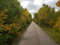 Beautiful tree-lined foot and bike path in autumn in Assiniboine Forest in Winnipeg, Manitoba, Canada Royalty Free Stock Photo