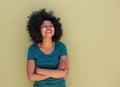 Beautiful trendy woman standing and smiling with arms crossed