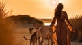 beautiful tribal woman with long hair and gepard on sunset in savanna and beach , wild animals nature landscape Royalty Free Stock Photo