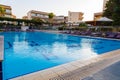 Beautiful tropical beach front hotel resort with swimming pool, sun-loungers and palm trees during warm sunny day, paradise Royalty Free Stock Photo