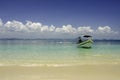 Beautiful tropical beach at Kapas Island, Malaysia. tourist boat anchored with blue sky background and crystal clear blue sea wate Royalty Free Stock Photo