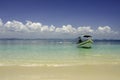 Beautiful tropical beach at Kapas Island, Malaysia. tourist boat anchored with blue sky background and crystal clear blue sea Royalty Free Stock Photo
