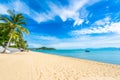 Beautiful tropical beach sea and ocean with coconut palm tree  and umbrella and chair on blue sky and white cloud Royalty Free Stock Photo