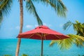 Beautiful tropical beach sea ocean with umbrella and chair around coconut palm tree on blue sky Royalty Free Stock Photo