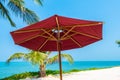 Beautiful tropical beach sea ocean with umbrella and chair around coconut palm tree on blue sky Royalty Free Stock Photo