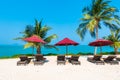 Beautiful tropical beach sea ocean with umbrella and chair around coconut palm tree on blue sky Royalty Free Stock Photo