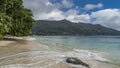 Beautiful tropical beach. The waves of the turquoise ocean are foaming on the sand. Royalty Free Stock Photo