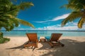 beautiful tropical beach with white sand and two sunbeds framed with palms. Bright crystal clear see. tropical vacation Royalty Free Stock Photo