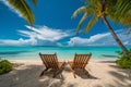 beautiful tropical beach with white sand and two sunbeds framed with palms. Bright crystal clear see. tropical vacation Royalty Free Stock Photo