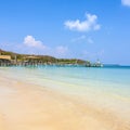 Beautiful tropical beach with wooden pier Royalty Free Stock Photo