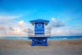 Beautiful tropical Florida landscape with blue lifeguard house at sunset twilight. American beach ocean scenic nature view with