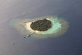 Beautiful tropical island at ocean aerial view from seaplane at Maldives Royalty Free Stock Photo