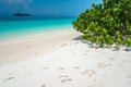 Beautiful tropical island white sand beach blue sky sunny day - Royalty Free Stock Photo