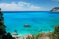 Beautiful tropical lagoon seascape with white boat in blue water. Royalty Free Stock Photo