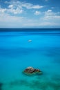 Beautiful tropical lagoon seascape with white boat in blue water. Royalty Free Stock Photo