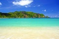 Beautiful tropical lagoon, white sand beach, turquoise water, green rock hill, blue summer sky - Kuta , Indonesia