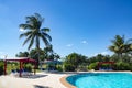 Beautiful tropical resort with swimming pool, sun-loungers and palm trees during a warm sunny day, vacations in Cuba Royalty Free Stock Photo