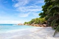 Beautiful tropical sand beach with granite rocks and coconut palm trees. La Digue, Seychelles Royalty Free Stock Photo