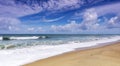 Beautiful Tropical sandy beach with blue ocean and blue sky background and wave crashing on sandy shore Royalty Free Stock Photo