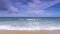 Beautiful Tropical sandy beach with blue ocean and blue sky background and wave crashing on sandy shore Royalty Free Stock Photo