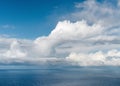 Beautiful tropical sunny summer day seascape with big white cumulus clouds in sky over blue sea water. Royalty Free Stock Photo