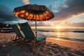 Beautiful tropical sunset landscape, two sunbeds, umbrella under palm tree