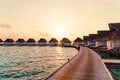 Beautiful tropical sunset over Maldives island with water bungalow in hotel resort Royalty Free Stock Photo