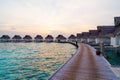 Beautiful tropical sunset over Maldives island with water bungalow in hotel resort Royalty Free Stock Photo