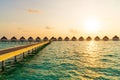 Beautiful tropical sunset over Maldives island with water bungalow in hotel resort Royalty Free Stock Photo