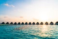 Beautiful tropical sunset over Maldives island with water bungalow in hotel resort Royalty Free Stock Photo