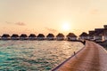 Beautiful tropical sunset over Maldives island with water bungalow in hotel resort Royalty Free Stock Photo