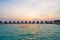 Beautiful tropical sunset over Maldives island with water bungalow in hotel resort Royalty Free Stock Photo