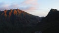 Beautiful tropical valley between cliifs with the first rays of the rising sun illuminate the mountain peaks. Aerial