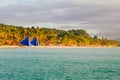 Beautiful tropical white sand beach with coconut palms and people on the beach Royalty Free Stock Photo