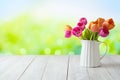 Beautiful tulip flower bouquet on white wooden table over green garden bokeh. Outdoor mock up for design and product display Royalty Free Stock Photo