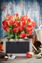 Beautiful tulips bouquet, easter eggs and garden tools on woode Royalty Free Stock Photo